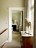 Equestrian statue on marble topped chest in hallway of East Sussex country house England UK