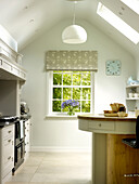 Breakfast bar and range oven with pendant light and skylights in Nottinghamshire home England UK