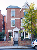 Three storey brick exterior of London semi-detached house, UK