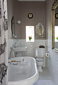 Freestanding bath with sunlit window in Hove home East Sussex UK