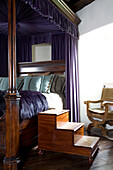 Wooden steps to four poster bed in Scottish home UK