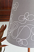 Close up of floral embroidered grey lampshade in East Sussex home, England, UK
