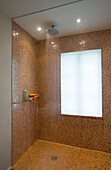 Power shower with frosted glass window in London home UK