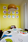 Wall mounted decorative plates in dining room London UK
