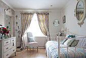 Hand mirrors displayed in pastel blue bedroom with metal daybed in Berkshire home, England, UK