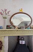 Oval shaped mirror on mantlepiece of Rye home, East Sussex, England, UK