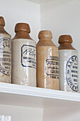 Antique ceramic storage jars on shelf in Surrey home, England, UK