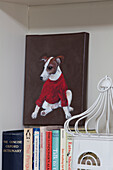 OIl painting of pet dog above reference books in Surrey home, England, UK