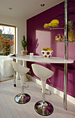 White barstools in retro styled kitchen of East Sussex home, England, UK