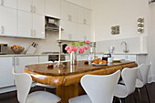White kitchen in London townhouse with antique table