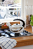 Duck-shaped kettle on hob with dishcloth London