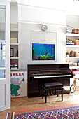 Piano and aquarium in contemporary London townhouse, England, UK