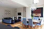 Table for eight in open plan dining, living room of classic London townhouse, UK