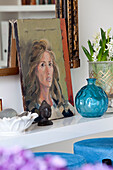 Oil painting and vintage ornaments on shelf in London home, UK