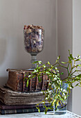 Pot pourri on old books with sprig of mistletoe in London home, England, UK