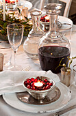 Lit tealight in bowl of berries, Christmas dinner, London home, England, UK