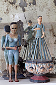 Old figurines and distressed mirror on mantlepiece in London townhouse, England, UK