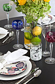 Vintage wine glasses at place settings of dining table in London apartment, UK