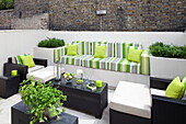Striped upholstery on garden seating in courtyard of contemporary London townhouse, England, UK