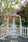 White painted gate and footpath at exterior of Dulwich home, London, England, UK