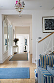 Open plan hallway with large mirror in Dulwich home, London, England, UK