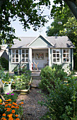 Painted summerhouse in back garden of Dorset cottage, England, UK