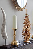 Gold candlesticks and tusks on marble fireplace in London townhouse, England, UK