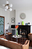Vintage furniture with Victorian fireplace in London townhouse, England, UK