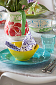 Colourful place setting on dining table in Herefordshire home England UK