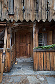 Vintage skis in paved entrance of mountain chalet in Chateau-d'Oex, Vaud, Switzerland
