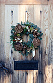 Christmas wreath on wooden front door of Chilterns home England UK