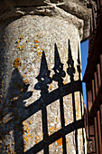 Wrought iron metal railings, shadow on stone pillar in the Loire, France