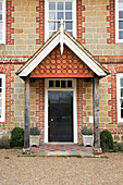 Stone and brickwork surrounding porch of London detached home England UK