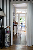 Vintage china umbrella stand at doorway in contemporary London home, England, UK