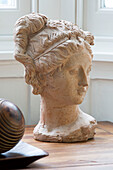Bust of a female head on wooden sideboard in London home, England, UK