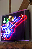 'Rock and Roll' neon sign in timber framed farmhouse, UK