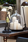 Candle storage with figurine and desk lamp on desk in Twickenham townhouse, Middlesex, England, UK