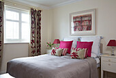Co-ordinating fabrics on double bed in London family home, England, UK