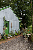 Green paintwork on corrugated metal shed with outdoor furniture Ceredigion Wales UK