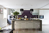 Four clear bar stools at breakfast bar in contemporary Berkshire kitchen, England, UK