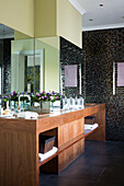 Mirrored double wash stand unit in mosaic tiled bathroom of Berkshire home, England, UK