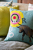 Bull and target on cushion in Camber cottage East Sussex England UK