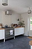 Stainless steel oven with metal lampshades in Presteigne cottage Wales UK
