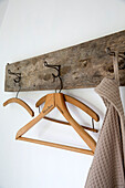 Wooden clothes hangers on hooks in Presteigne cottage Wales UK