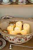 Lit candles in vintage bowl with candle snuff in Berkshire home,  England,  UK