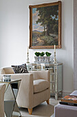 Framed artwork above mirrored sideboard in contemporary London living room   UK
