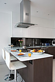 Kitchen extractor above breakfast bar in contemporary London home   UK