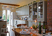 Fairylights and lit candle in open plan kitchen dining room at Christmas in Dronfield home  Derbyshire  England  UK