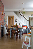 Wooden dining table and chairs in open plan dining room of Dronfield home  Derbyshire  England  UK