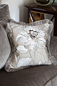 Floral cushion on sofa in living room of London home   England   UK